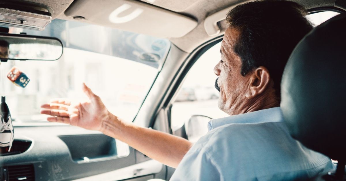 Should car seat go behind driver or passenger?